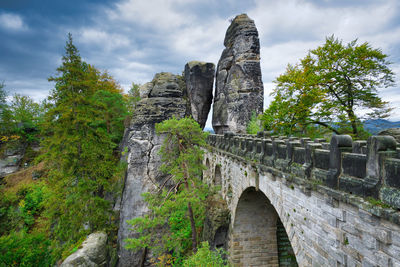 Bastei, low angle view of old ruin building against cloudy sky
