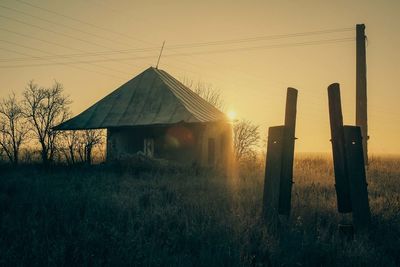 Built structure on field at sunset