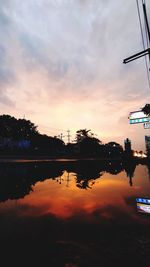 Scenic view of lake against orange sky