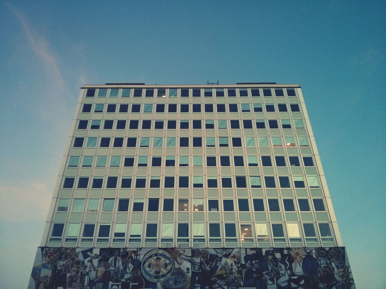 architecture, low angle view, building exterior, built structure, window, blue, building, glass - material, clear sky, modern, pattern, office building, reflection, sky, city, day, outdoors, repetition, architectural feature, no people