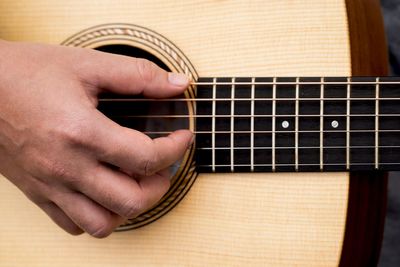 Close-up of hands playing guitar