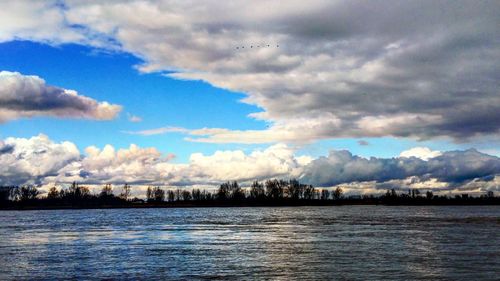 Scenic view of sea against cloudy sky