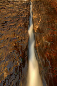 Low section of person on waterfall