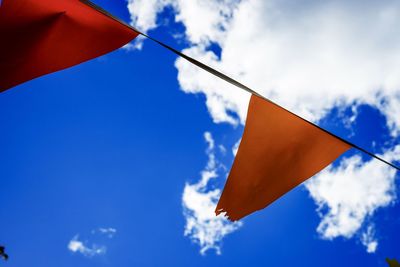 Close-up of flags against blue sky