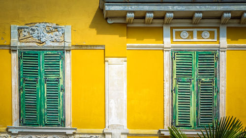 Low angle view of yellow windows on building