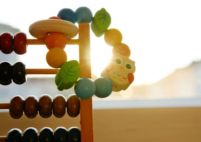 Close-up of multi colored toy on wood against sky