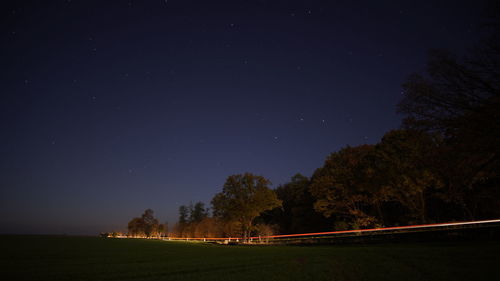 Scenic view of field against sky at night