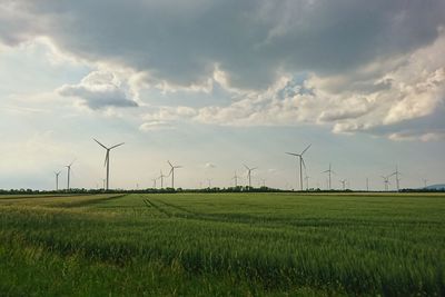 Windmill on field against sky