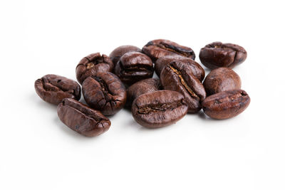 High angle view of coffee beans against white background