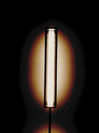 Close-up of illuminated lamp against black background