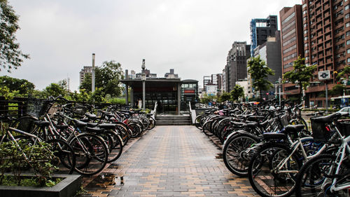 Bicycles parked in row against sky