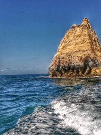 Scenic view of sea against clear blue sky