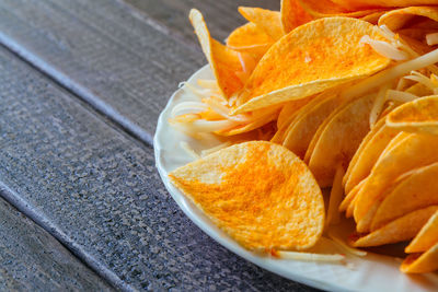 Close-up of potato chips in plate on table