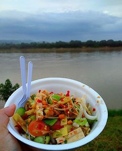 Food on lake against sky