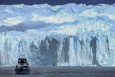 Boat on lake against moreno glacier