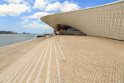 Bridge over sea against sky in city