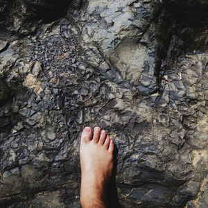 View of human feet on tiled floor