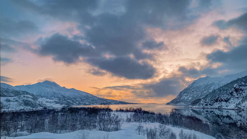 Scenic view of snowcapped mountains against sky during sunset