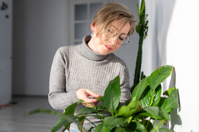 Portrait of woman holding plant