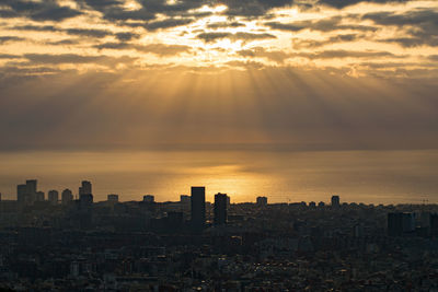 Scenic view of buildings against sky during sunset