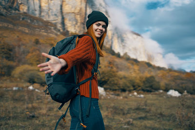 Portrait of smiling young woman standing outdoors