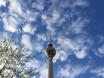 Low angle view of tv tower against cloudy sky