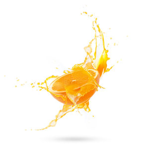 Close-up of yellow splashing water against white background