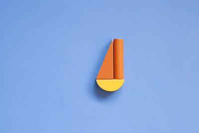 Close-up of yellow umbrella against blue sky