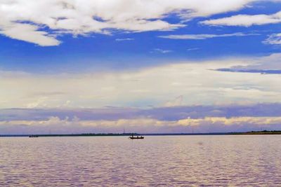 Scenic view of sea against cloudy sky