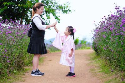 Full length of woman with pink flowers