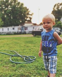 Portrait of cute boy standing at yard