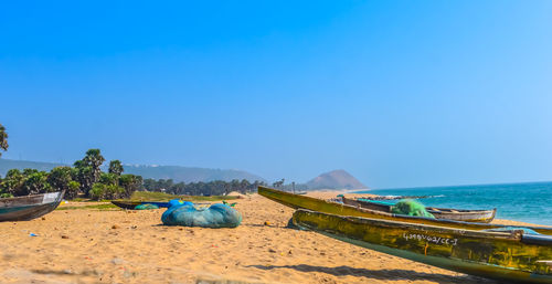 Scenic view of beach against clear blue sky