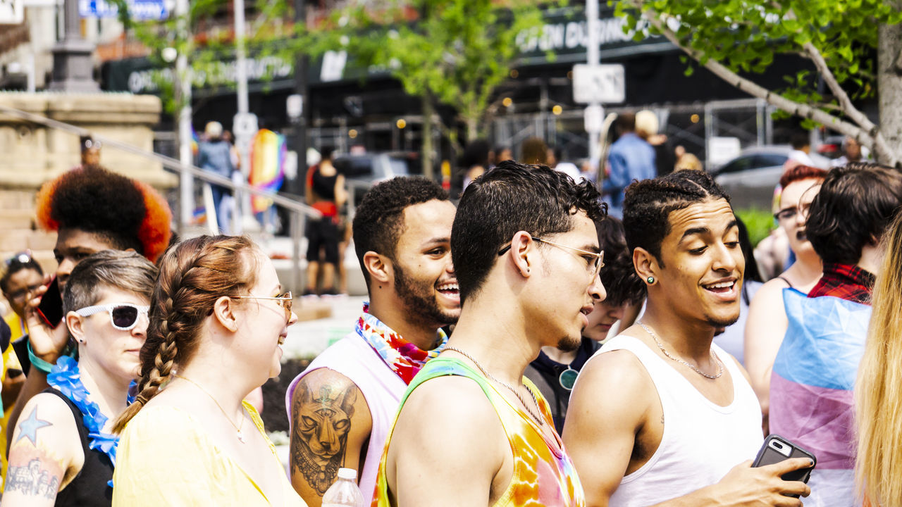 group of people, real people, crowd, large group of people, lifestyles, city, street, day, young adult, focus on foreground, togetherness, adult, men, young men, event, celebration, outdoors, looking, women, festival