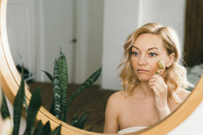 Portrait of smiling young woman sitting at home