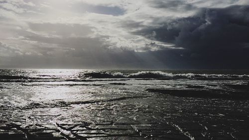 View of calm sea against cloudy sky