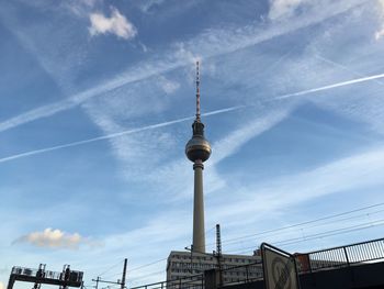 Low angle view of tower against cloudy sky