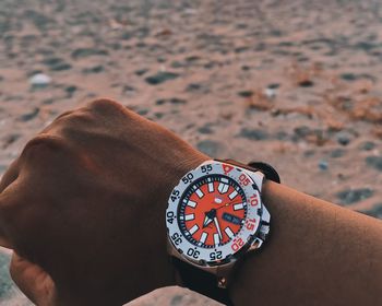 Close-up of hand holding clock