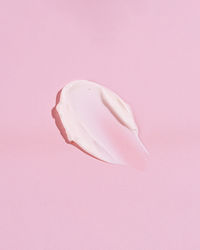 Close-up of dentures against pink background