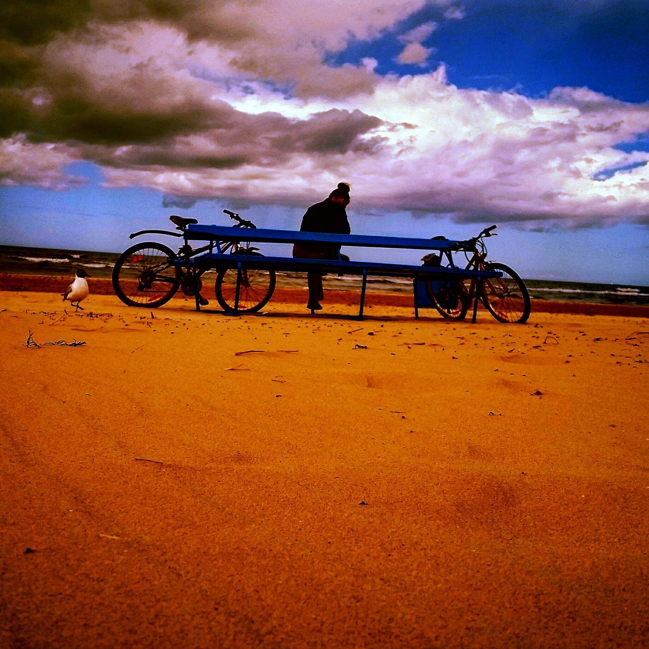 sky, bicycle, cloud - sky, transportation, mode of transport, beach, cloudy, land vehicle, cloud, sand, sunset, stationary, sea, shore, scenics, tranquility, tranquil scene, outdoors, nature, silhouette