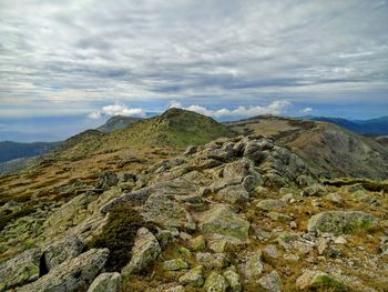 Scenic view of mountains against cloudy sky