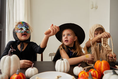 Portrait of smiling young woman sitting at home