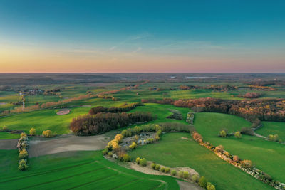 Scenic view of land against sky during sunset