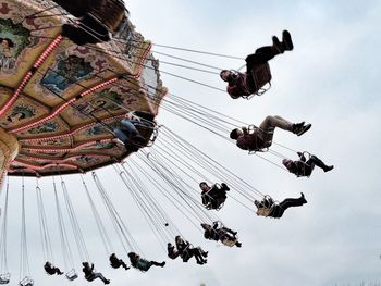 Low angle view of people in amusement park