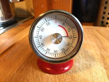 Close-up of clock on table