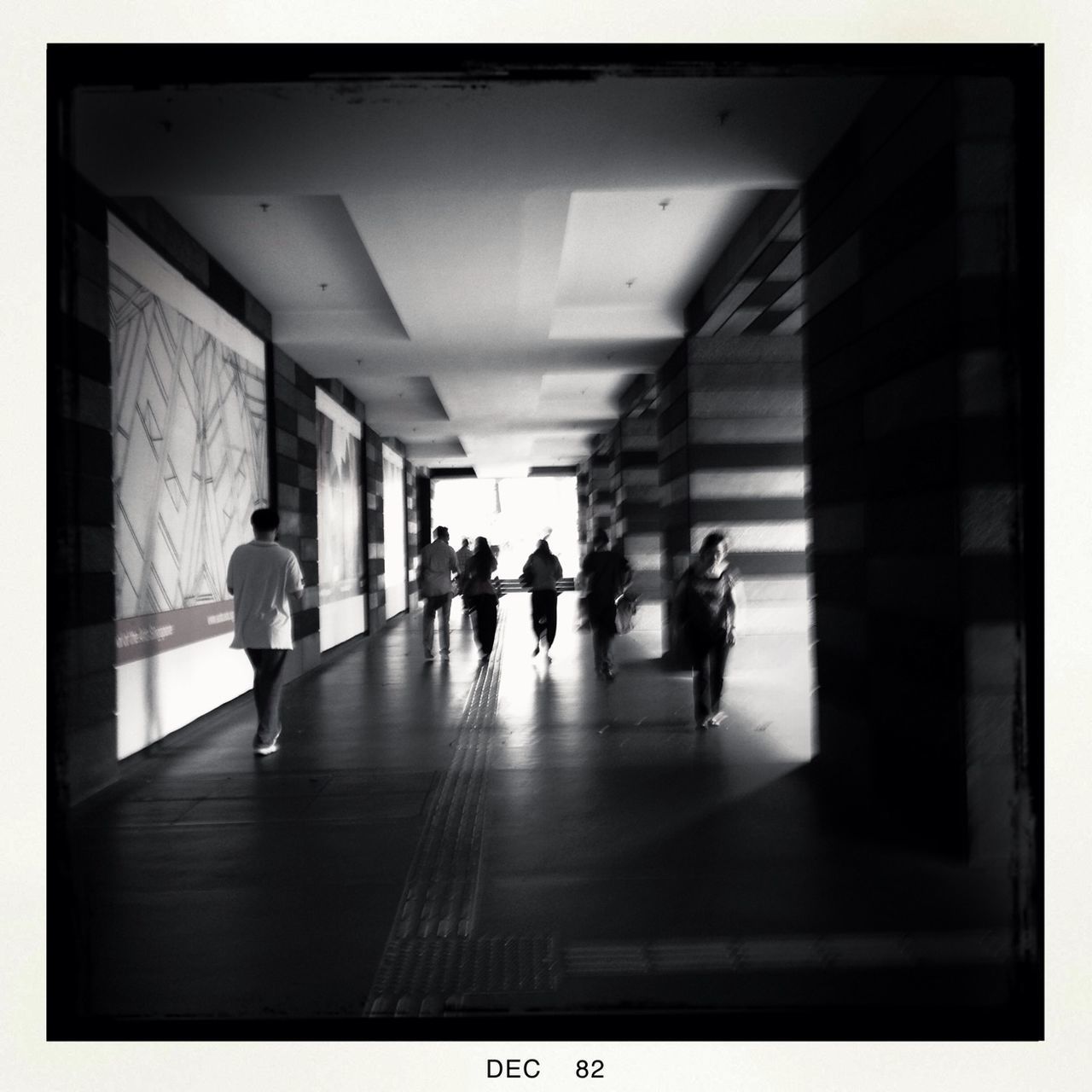 indoors, men, lifestyles, walking, person, full length, leisure activity, architecture, rear view, built structure, subway, city life, subway station, corridor, togetherness, the way forward, silhouette