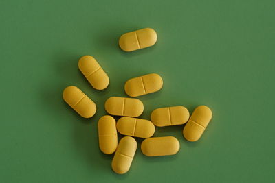 Pills isolated on green background