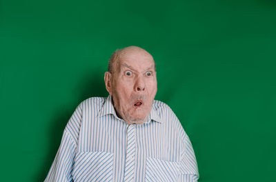 Portrait of man wearing hat against gray background