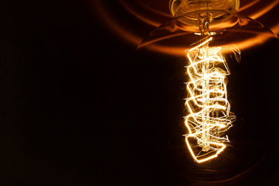 Low angle view of illuminated lamp post at night