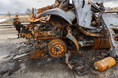 Burnt military vehicles of russian soldiers on the bridge across the river. rusty cars.
