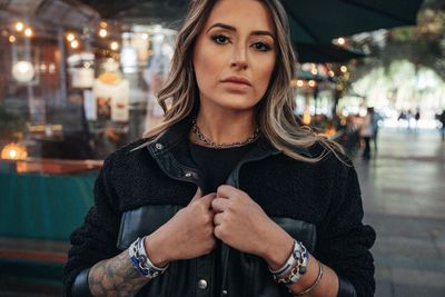 Portrait of young woman standing outdoors